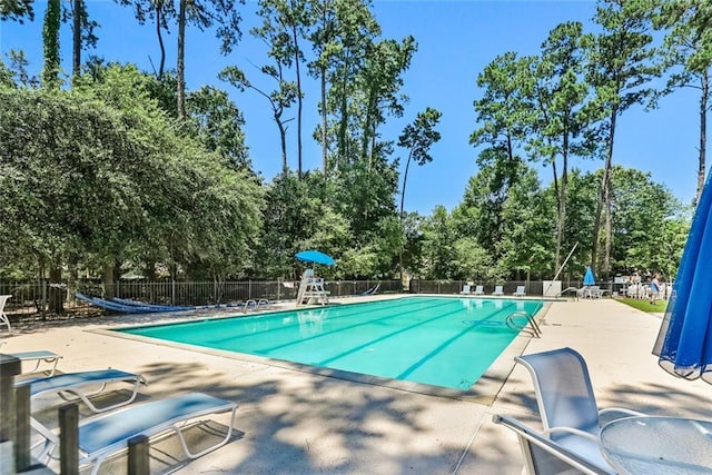 1061 Tallow Tree Dr, Mandeville, LA 70448 - community pool featuring a patio area and view of scattered trees