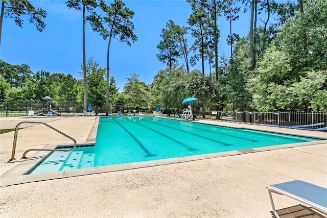 1061 Tallow Tree Dr, Mandeville, LA 70448 - community pool featuring a patio area and view of scattered trees