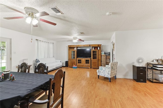 303 Clearwood Dr, Slidell, LA 70458 - dining area featuring a ceiling fan, light wood-type flooring, and a textured ceiling