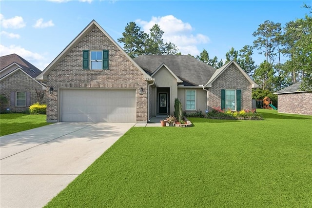 728 Fairfield Loop, Slidell, LA 70458 - view of front of house featuring a front yard, driveway, a playground, and brick siding