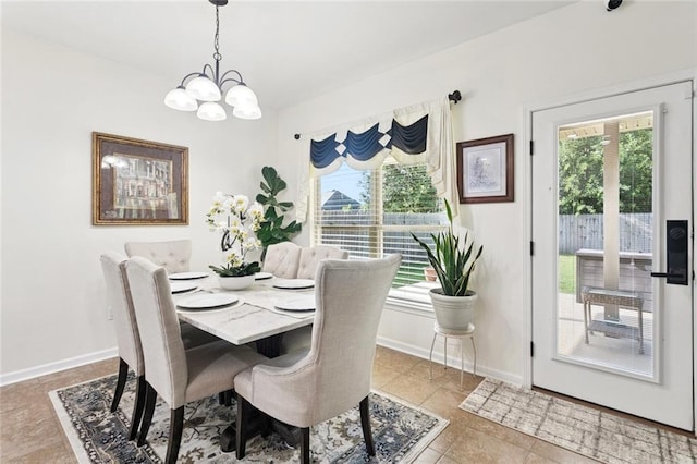 728 Fairfield Loop, Slidell, LA 70458 - dining area with a chandelier, healthy amount of natural light, baseboards, and tile patterned floors