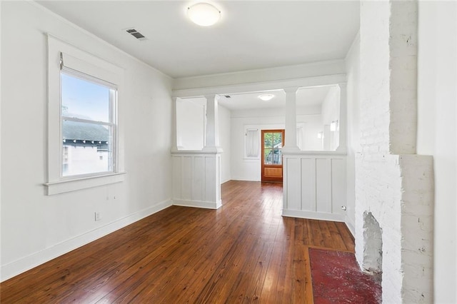 3019 Burdette St, New Orleans, LA 70125 - empty room with hardwood / wood-style floors, decorative columns, and baseboards