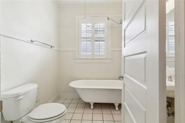 3019 Burdette St, New Orleans, LA 70125 - bathroom featuring a freestanding bath, toilet, tile patterned flooring, and baseboards
