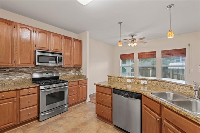 816 Celeste Ave, River Ridge, LA 70123 - kitchen with stainless steel appliances, a sink, backsplash, a ceiling fan, and hanging light fixtures