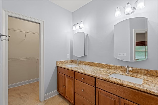 816 Celeste Ave, River Ridge, LA 70123 - full bathroom featuring double vanity, baseboards, and a spacious closet