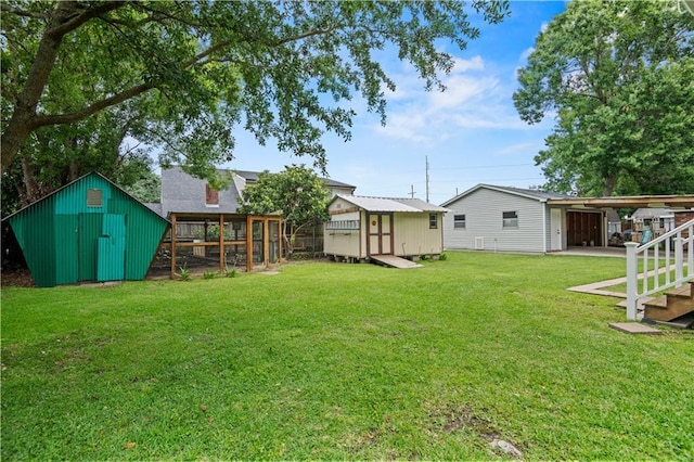 816 Celeste Ave, River Ridge, LA 70123 - view of green lawn featuring exterior structure and a carport