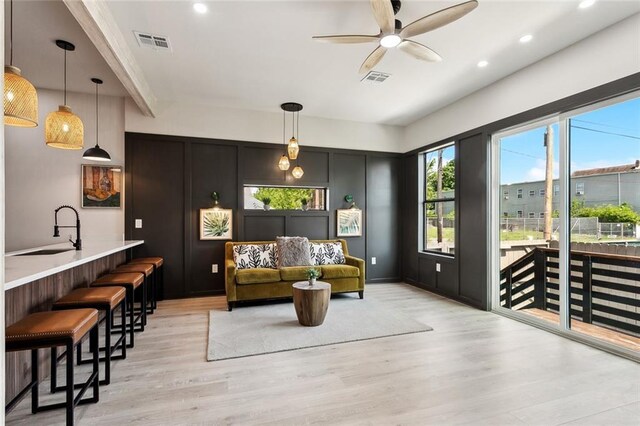 2404 Danneel St, New Orleans, LA 70113 - living area with light wood finished floors, a ceiling fan, and recessed lighting