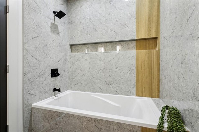 2404 Danneel St, New Orleans, LA 70113 - full bath featuring a tub with marble appearance and a shower