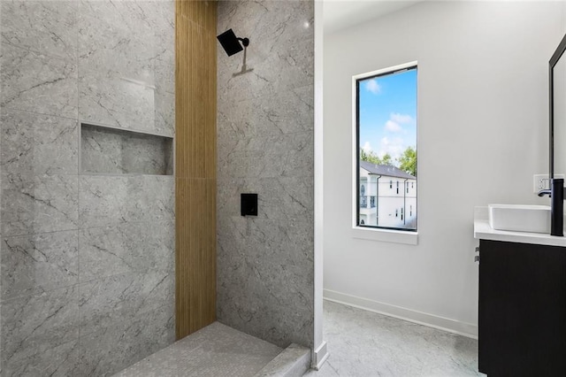 2404 Danneel St, New Orleans, LA 70113 - bathroom with tiled shower, vanity, and baseboards
