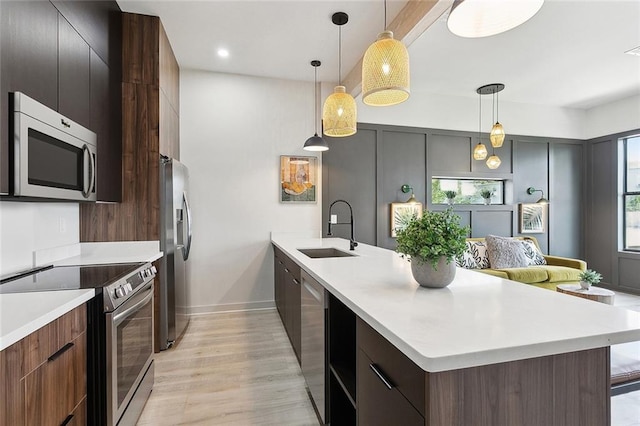 2404 Danneel St, New Orleans, LA 70113 - kitchen with appliances with stainless steel finishes, a sink, modern cabinets, and light countertops