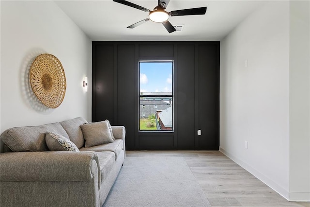 2404 Danneel St, New Orleans, LA 70113 - living area featuring light wood-type flooring, ceiling fan, and baseboards