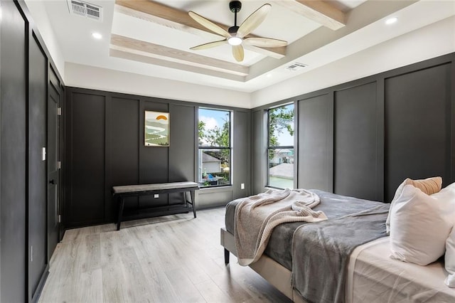 2404 Danneel St, New Orleans, LA 70113 - bedroom featuring a decorative wall, light wood-type flooring, ceiling fan, beamed ceiling, and recessed lighting