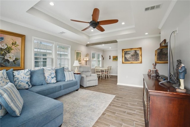 133 Creagan Ave, Gretna, LA 70053 - living room featuring baseboards, light wood-style floors, a ceiling fan, a tray ceiling, and recessed lighting