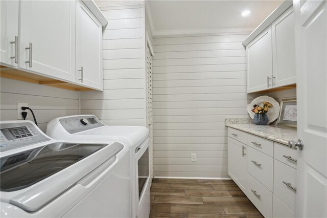 133 Creagan Ave, Gretna, LA 70053 - laundry area featuring washer and clothes dryer, dark wood finished floors, cabinet space, wooden walls, and baseboards