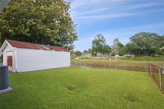 133 Creagan Ave, Gretna, LA 70053 - view of yard with central air condition unit, a water view, and an outbuilding