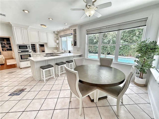 44 Stonebridge Ct, Mandeville, LA 70448 - dining area featuring light tile patterned floors, ceiling fan, recessed lighting, and crown molding