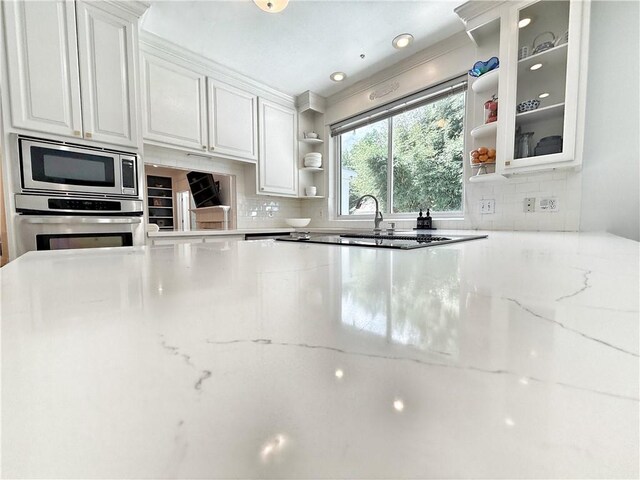 44 Stonebridge Ct, Mandeville, LA 70448 - kitchen featuring appliances with stainless steel finishes, open shelves, white cabinets, and decorative backsplash