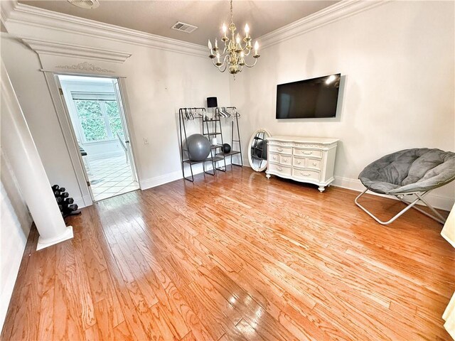 44 Stonebridge Ct, Mandeville, LA 70448 - living area featuring hardwood / wood-style flooring, crown molding, baseboards, and a chandelier