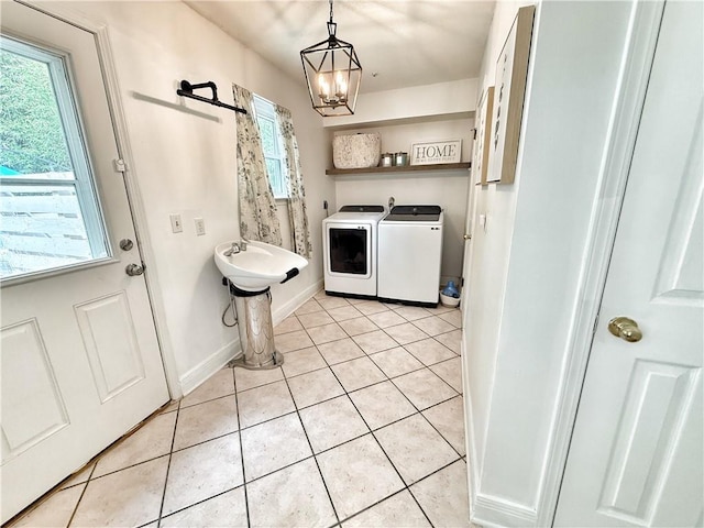 44 Stonebridge Ct, Mandeville, LA 70448 - washroom with separate washer and dryer, light tile patterned flooring, a chandelier, and baseboards