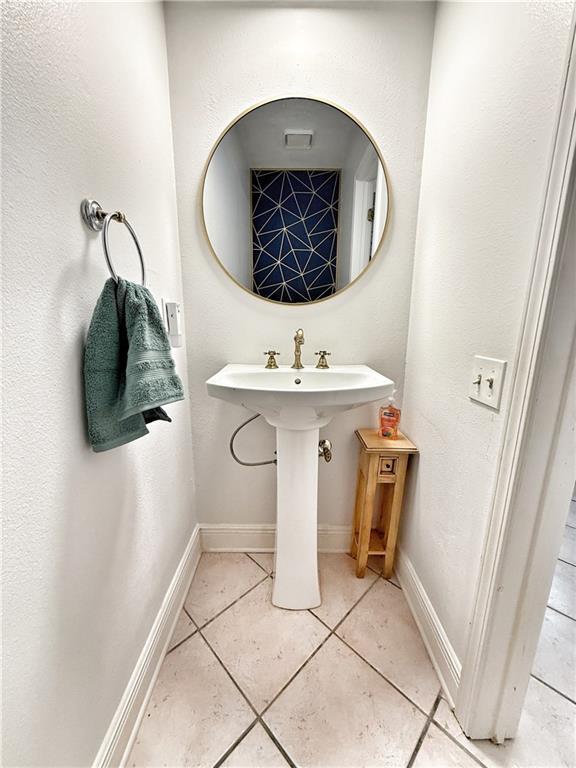 44 Stonebridge Ct, Mandeville, LA 70448 - bathroom with tile patterned flooring, baseboards, and a sink