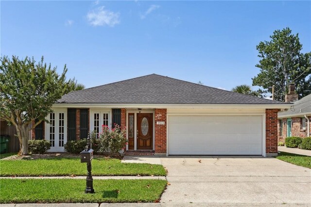 3513 9th St, Metairie, LA 70002 - ranch-style home with concrete driveway, an attached garage, brick siding, and a front lawn