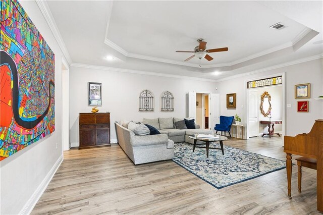 5714 Vicksburg St, New Orleans, LA 70124 - living area with a tray ceiling, ceiling fan, wood finished floors, crown molding, and baseboards