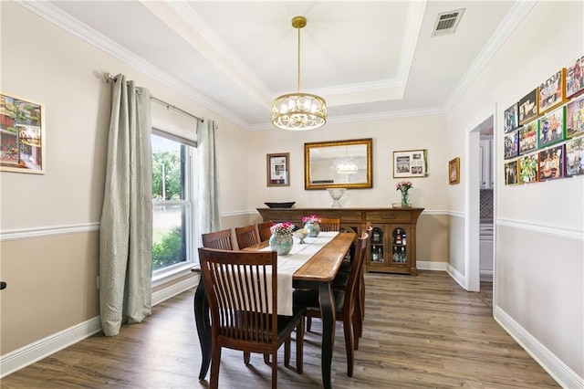 5714 Vicksburg St, New Orleans, LA 70124 - dining area featuring a chandelier, a raised ceiling, wood finished floors, crown molding, and baseboards