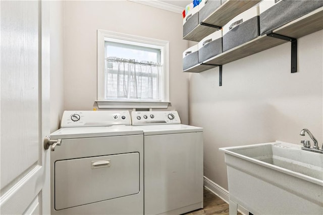5714 Vicksburg St, New Orleans, LA 70124 - laundry room featuring washing machine and clothes dryer, wood finished floors, and crown molding