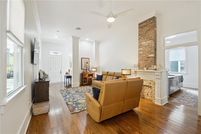 718 Monroe St, Gretna, LA 70053 - living area with ornamental molding, dark wood finished floors, healthy amount of natural light, ceiling fan, and baseboards
