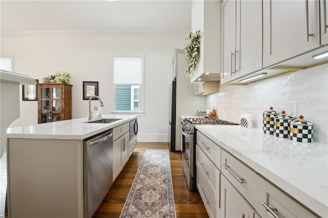 718 Monroe St, Gretna, LA 70053 - kitchen featuring stainless steel appliances, a sink, a kitchen island with sink, dark wood-style flooring, and tasteful backsplash