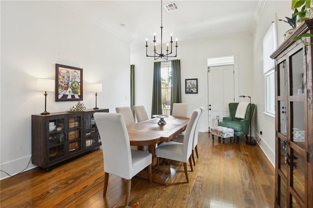 718 Monroe St, Gretna, LA 70053 - dining room with a chandelier, wood finished floors, and ornamental molding