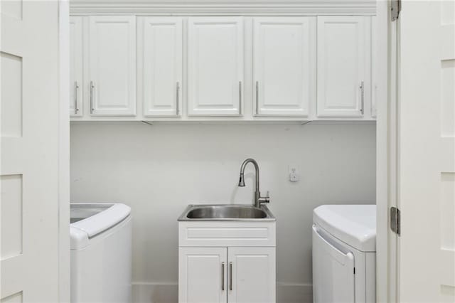 718 Monroe St, Gretna, LA 70053 - washroom featuring washer and dryer, cabinet space, and baseboards