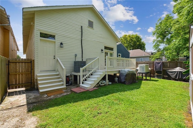 718 Monroe St, Gretna, LA 70053 - back of house featuring central AC unit, a deck, and entry steps