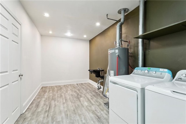 6909 Asher St, Metairie, LA 70003 - laundry room featuring independent washer and dryer, light wood-type flooring, recessed lighting, and water heater