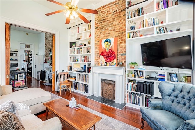352123 Cleveland Ave, New Orleans, LA 70119 - living area with a high end fireplace, ceiling fan, wood finished floors, and built in shelves