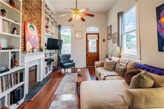 352123 Cleveland Ave, New Orleans, LA 70119 - living area with a fireplace, ceiling fan, dark wood-style flooring, and built in features