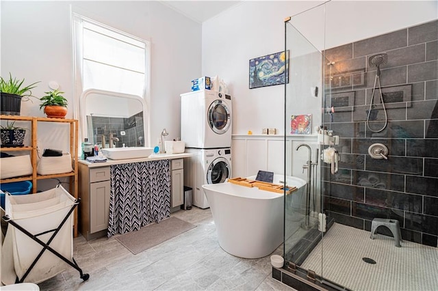 352123 Cleveland Ave, New Orleans, LA 70119 - full bathroom with stacked washer / dryer, a stall shower, vanity, and a soaking tub