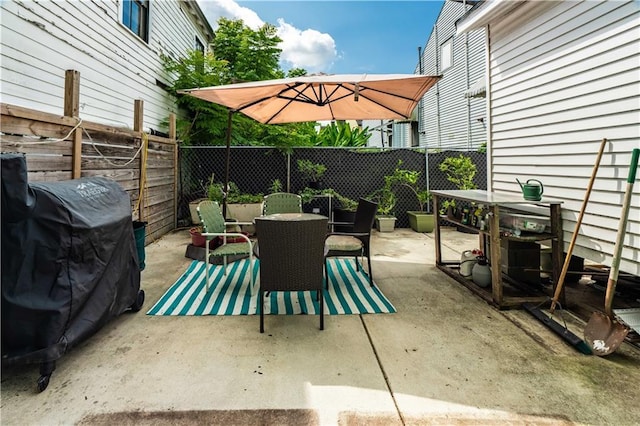 352123 Cleveland Ave, New Orleans, LA 70119 - fenced backyard featuring outdoor dining area, a patio, and a grill