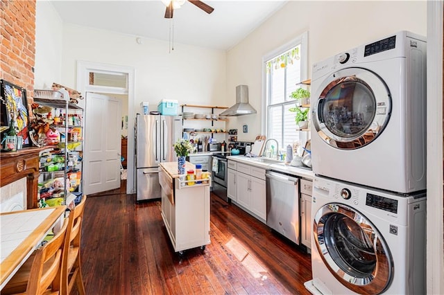352123 Cleveland Ave, New Orleans, LA 70119 - kitchen featuring appliances with stainless steel finishes, stacked washer / dryer, ceiling fan, light countertops, and a kitchen island