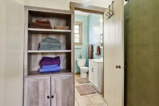 640 Lizardi St, New Orleans, LA 70117 - bathroom with vanity, toilet, and tile patterned floors