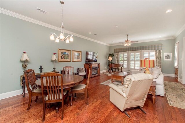 23783 Monarch Pt, Springfield, LA 70462 - dining space with baseboards, wood finished floors, ornamental molding, recessed lighting, and a ceiling fan