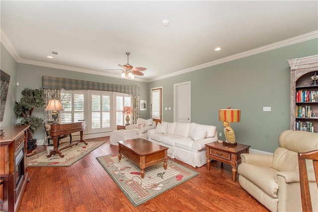 23783 Monarch Pt, Springfield, LA 70462 - living room featuring wood finished floors, ceiling fan, crown molding, and baseboards