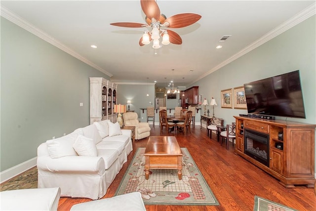 23783 Monarch Pt, Springfield, LA 70462 - living area with crown molding, ceiling fan, wood finished floors, recessed lighting, and a chandelier