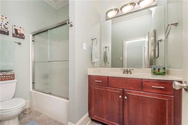 23783 Monarch Pt, Springfield, LA 70462 - bathroom featuring toilet, vanity, combined bath / shower with glass door, baseboards, and ornamental molding