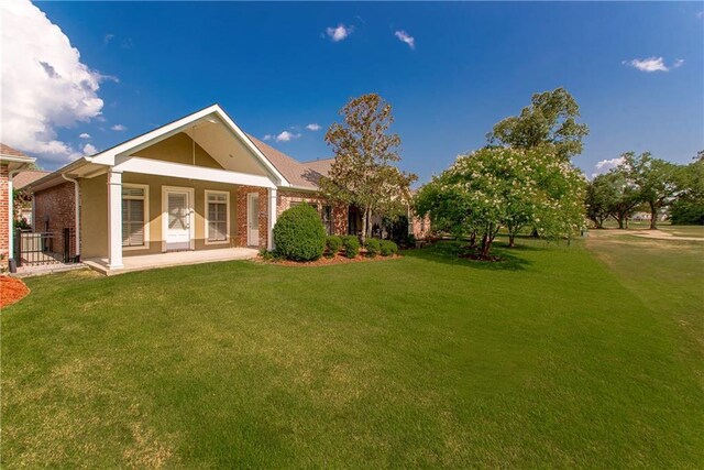 23783 Monarch Pt, Springfield, LA 70462 - back of property with a lawn, stucco siding, and brick siding