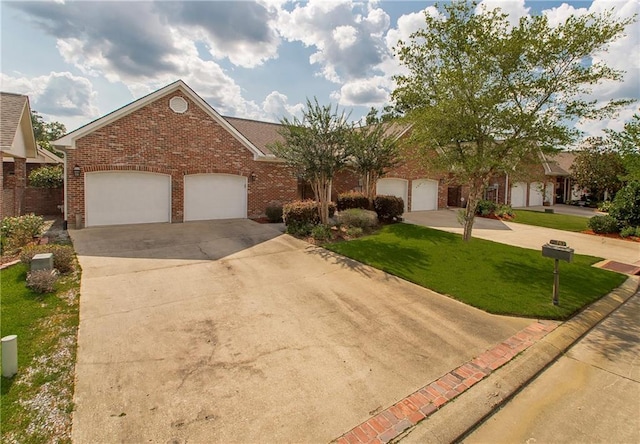 23783 Monarch Pt, Springfield, LA 70462 - view of front of home with concrete driveway, brick siding, a front yard, and an attached garage
