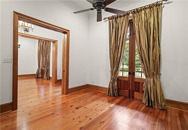580 Northwoods Dr, Abita Springs, LA 70420 - spare room featuring light wood-style floors, crown molding, ceiling fan, baseboards, and french doors