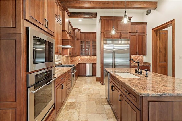 580 Northwoods Dr, Abita Springs, LA 70420 - kitchen with built in appliances, a sink, stone tile flooring, decorative backsplash, and brown cabinetry