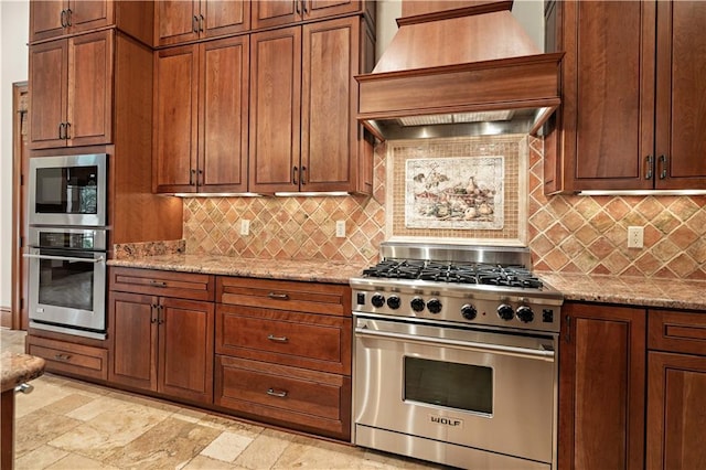 580 Northwoods Dr, Abita Springs, LA 70420 - kitchen with stainless steel appliances, premium range hood, decorative backsplash, and light stone counters