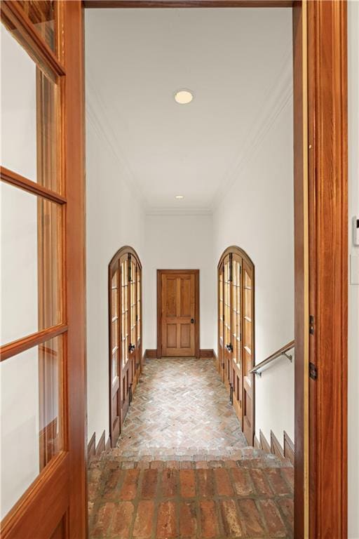 580 Northwoods Dr, Abita Springs, LA 70420 - hall with crown molding, french doors, brick flooring, and recessed lighting